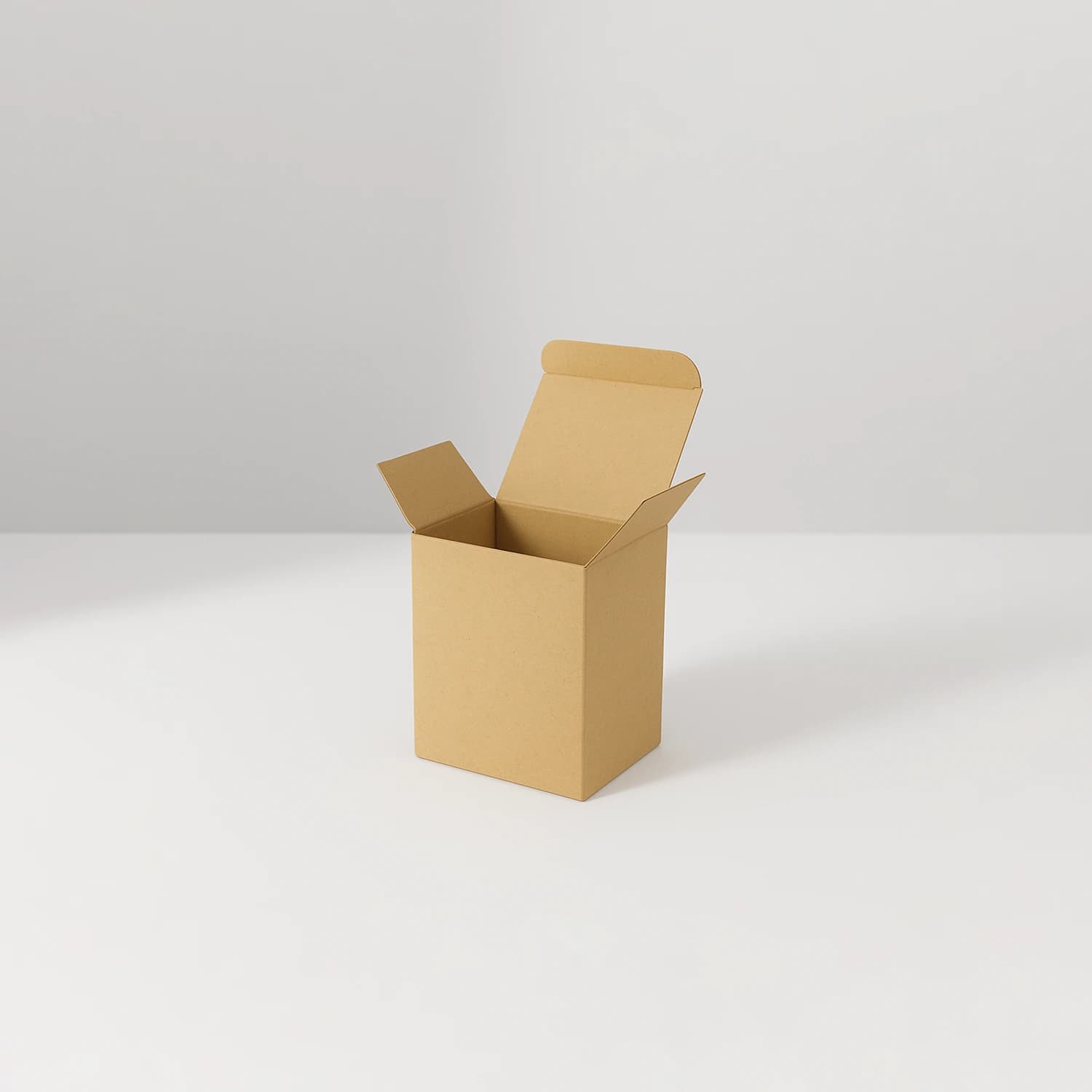 Kraft candle box with tuck-top flaps open on a white surface