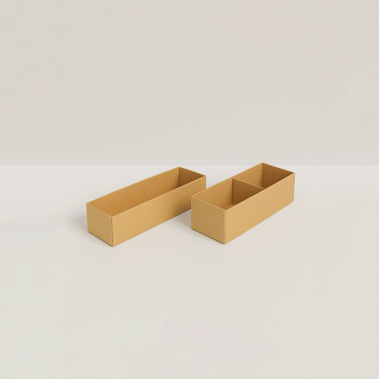 Two long kraft spare parts boxes, one with a central divider