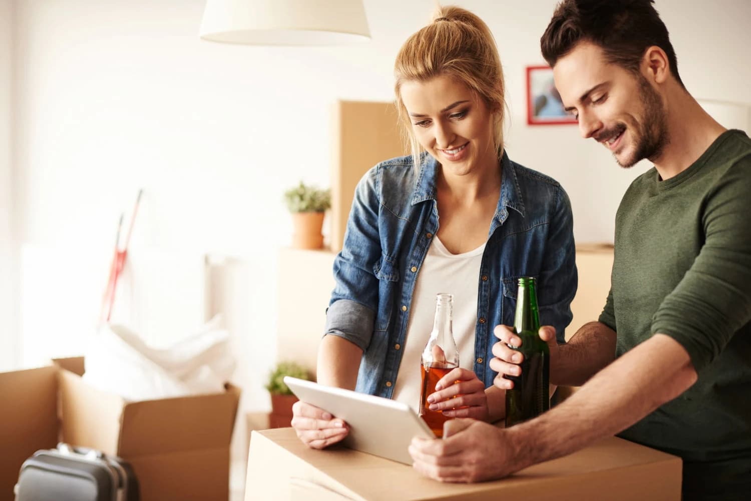 Holding 4-bottle pack of beer